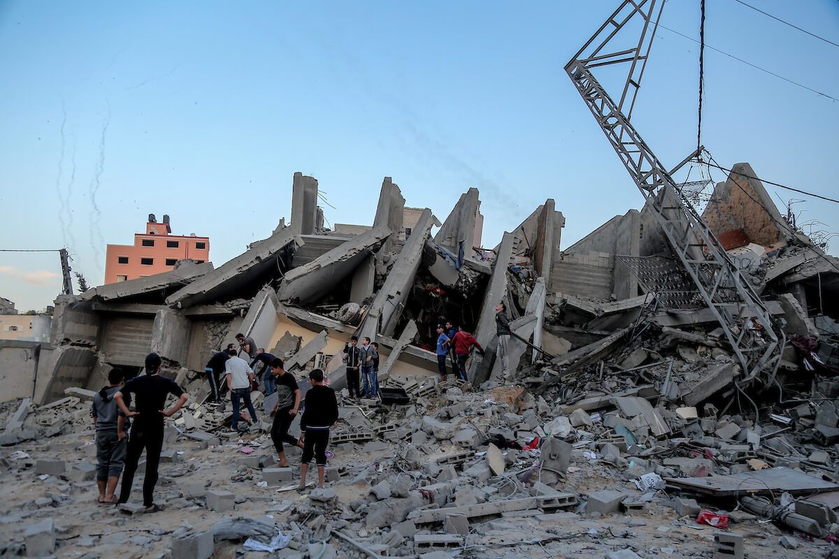Palestinians inspect the remains of a building following an Israeli airstrike, in Gaza city on May 5, 2019. Israeli warplanes hit the building on Saturday where Anadolu Agencys office is located.