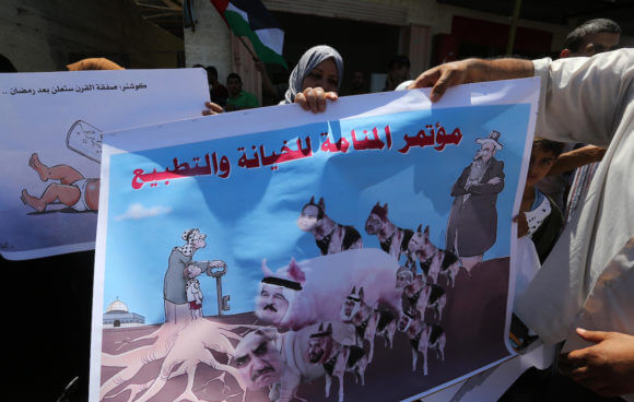 Palestinians protest President Donald Trump's Bahrain economic workshop, in Khan Younis in the southern of Gaza strip, on June 26, 2019. (Photo: Ashraf Amra)