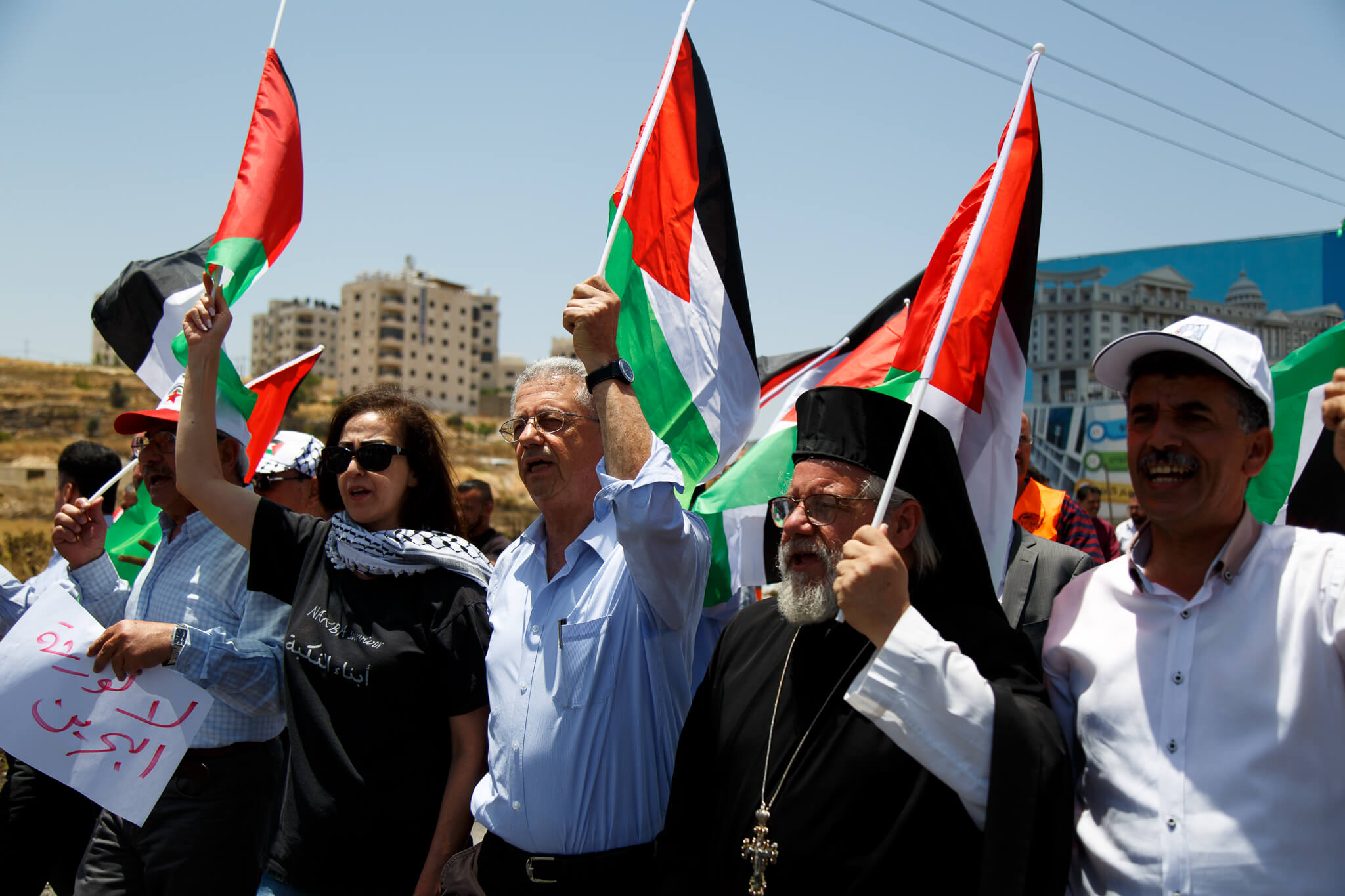 Mustafa Barghouti (center) protests the Trump administration's economic summit in Bahrain, outside of Ramallah, Wednesday June 26, 2019. (Photo: Miriam Deprez)