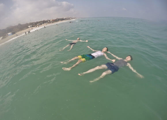 Palestinian beach goers enjoy swimming in Gaza, in the Mediterranean Sea.