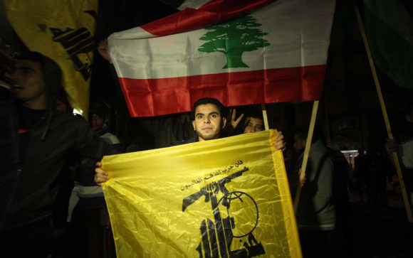 A Palestinian man waves Hezbollah' flag during a rally in Gaza city on January 28, 2015, after two Israeli soldiers and a Spanish peacekeeper were killed in an exchange of fire between Hezbollah and Israel. The soldiers were killed when Hezbollah fired a missile at a convoy of Israeli military vehicles on the frontier with Lebanon. (Photo: Ashraf Amra/APA Images)