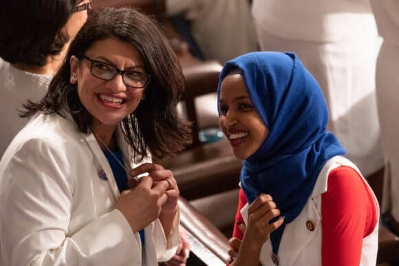 (L-R): Rep. Rashida Tlaib (D-MI), and Rep. Ilhan Omar (D-MN), talk, before U.S. President Donald Trump's second State of the Union address to a joint session of Congress at the U.S. Capitol in Washington, D.C., on Tuesday, Feb. 5, 2019. (Photo: Cheriss May/NurPhoto/Getty Images)