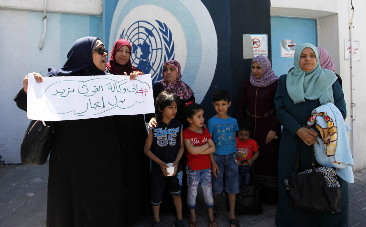Palestinian owners of houses that were destroyed during the 2014 war between Israel and Hamas take part in a protest in front of UNRWA headquarters, in Gaza City, on May 8, 2019. (Photo: Mahmoud Ajjour/APA Images)
