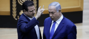 Ayman Odeh of the Joint List mocks Benjamin Netanyahu on the Knesset floor last week over Netanyahu's threat to put cameras in polling places, to intimidate Palestinian voters.