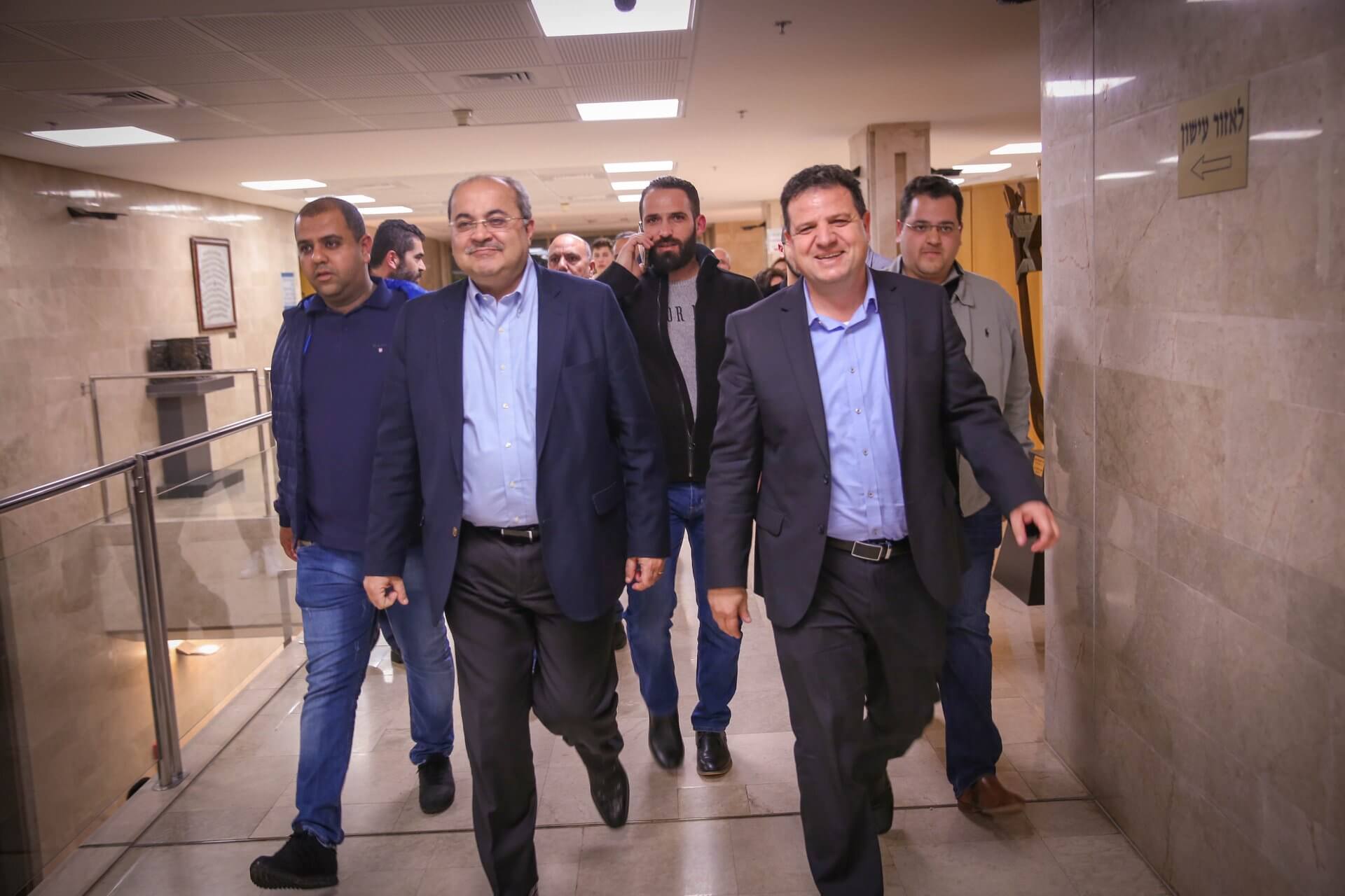 Head of the Joint List, Ayman Odeh (R), walks through the halls of Knesset with Joint List Knesset member Ahmad Tibi. The Joint List is a coalition of four Arab factions, Odeh leads the Hadash faction and Tibi leads the Ta'al movement, July 24, 2019. (Photo: Ayman Odeh/Facebook)