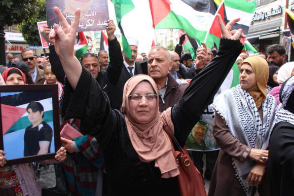 Palestinians take part in a protest to show solidarity with prisoners in Israeli jails, and marking Palestinian Prisoners' Day, in the West Bank city of Ramallah on April 17, 2019. (Photo: Ayat Arqawy/APA Images)