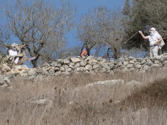 Israeli settlers attack farmers in the Nablus area village of Burin, October 2019 (Photo: Facebook)