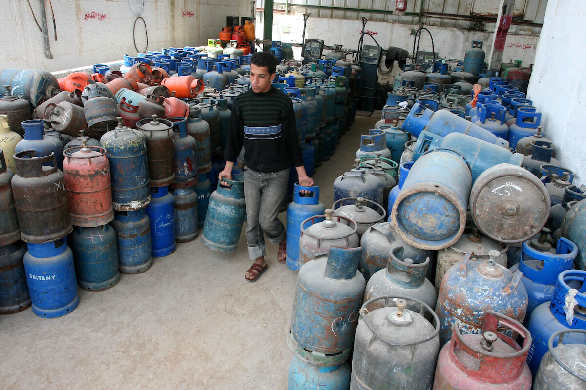 A Palestinian man stands next empty gas canisters at a natural gas station in Gaza City on April 13, 2011, as Gaza Strip suffers from the shortages of natural gas. (Photo: Mohammed Asad)