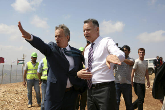 Middle East Quartet envoy Tony Blair (L) speaks with Palestinian-American entrepreneur Bashar Masri, June 22, 2010 on a hill outside the West Bank city of Ramallah where the "Rawabi" residential project is expected to accommodate 40,000 people, in a 700-million-dollar project, which is partly financed by a Qatari construction company, 2010. (Photo: Eyad Jadallah/APA Images)