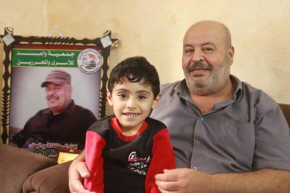 Suhail al-Amoudi with his grandson Mohammed after returning home.