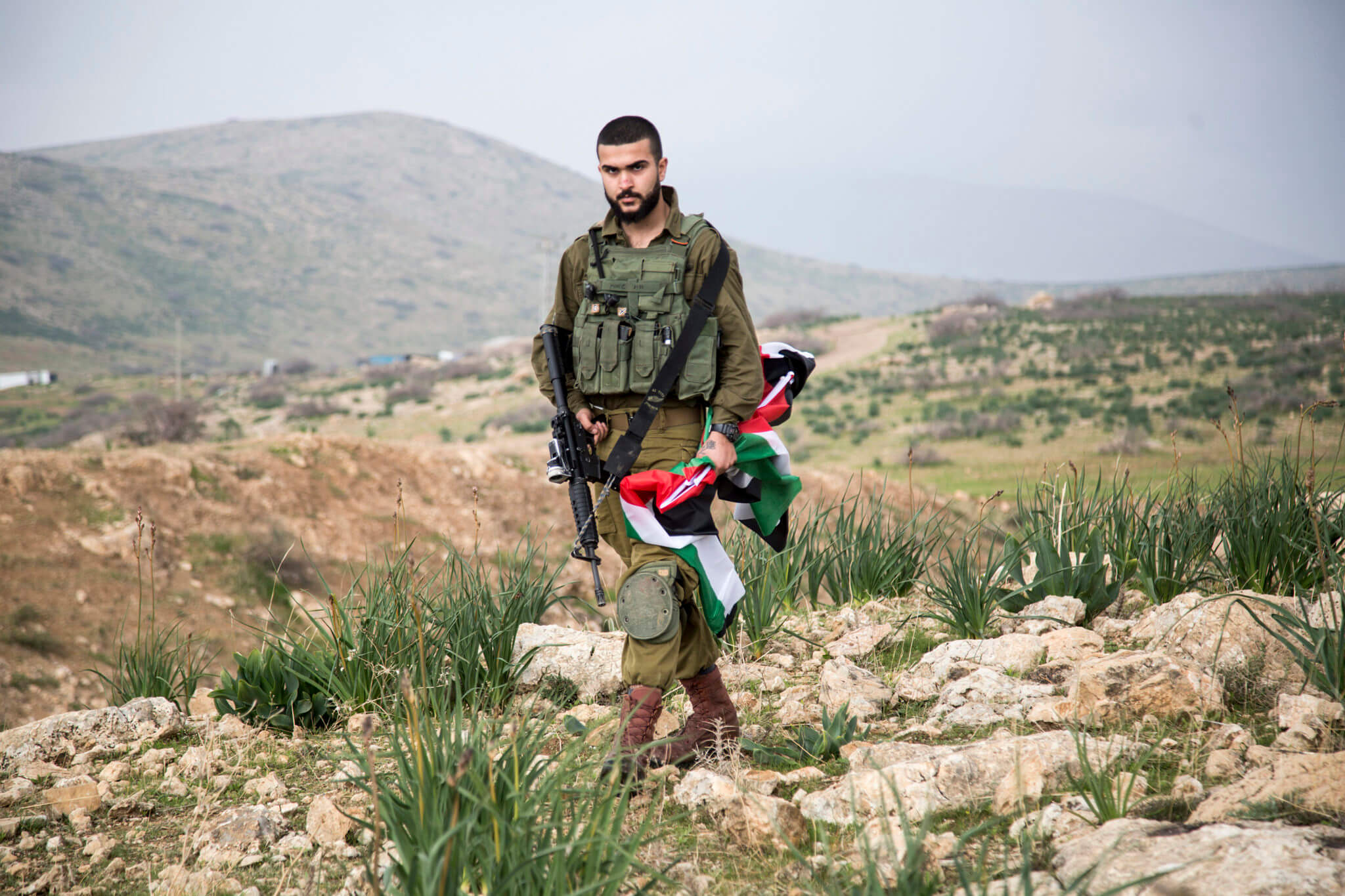 Israeli soldier confiscate Palestinian flags during a protest against President Donald Trump’s Middle East peace plan and an Israeli declaration to annex the Jordan Valley, near Hamra checkpoint, the Jordan Valley, the West Bank January 29, 2020. (Photo: Keren Manor / Activestills)