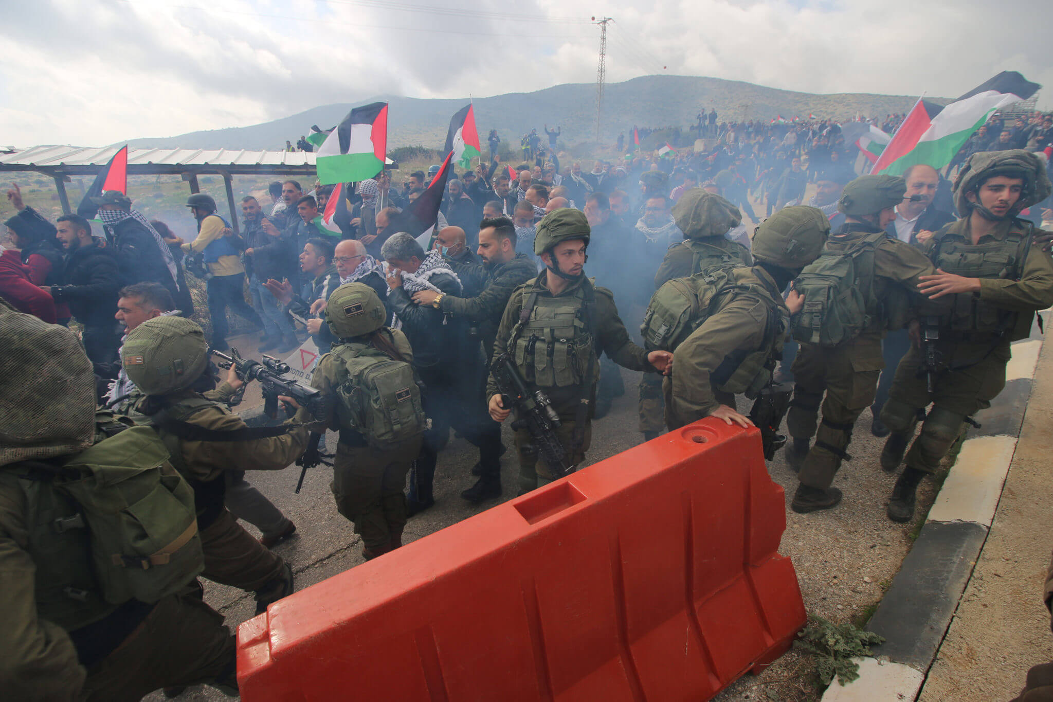 Israeli soldiers fire sound grenades at Palestinian protesters by the Tayseer checkpoint, the Jordan Valley, the West Bank, January 30, 2020. (Photo: Ahmad Al-Bazz / Activestills)