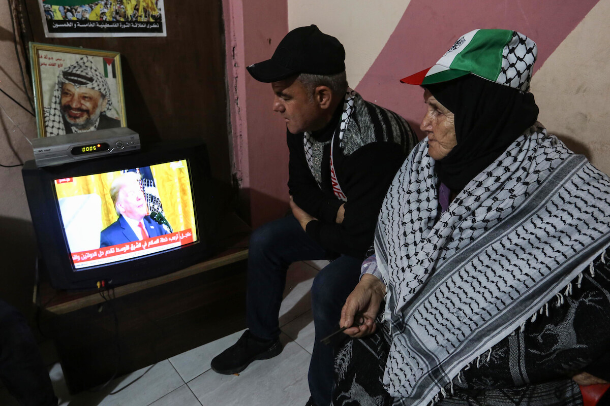 Palestinians watch the televised press conference of President Donald Trump and Israeli Prime Minister Benjamin Netanyahu in Khan Yunis in the southern of Gaza Strip on January 28, 2020. Donald Trump announced his ultimate deal for Middle East peace, saying his plan would be a realistic two-state solution that had already been agreed to by Israel. (Photo: Ashraf Amra/APA Images