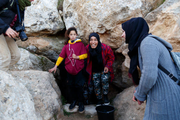 Women from a-Tuwani village fill containers with water from the Ein al-Beida spring for the first time in 15 years. (Photo: Miriam Deprez)