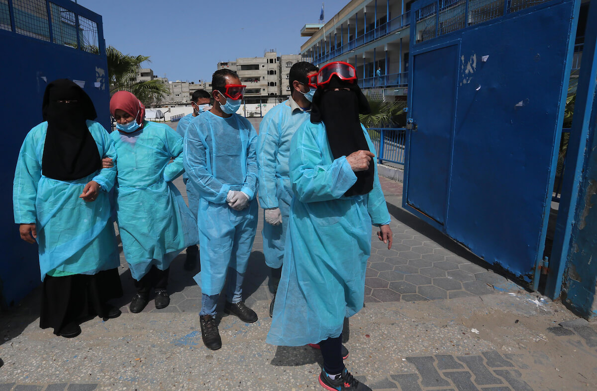 Palestinian members of the civil defense disinfect the streets as a preventive measure amid fears of the spread of the coronavirus, in Khan Younis in the southern of Gaza Strip, on March 23, 2020. (Photo: Ashraf Amra/APA Images)