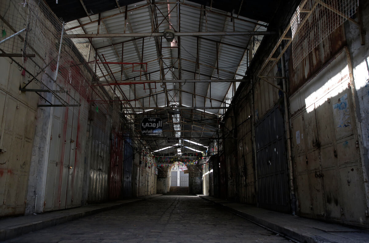 Shops are shuttered in an outdoor market after Palestinians are ordered to stay at home as a precaution against the spread of the coronavirus, in the West Bank city of Nablus, on March 25, 2020. (Photo: Shadi Jarar'ah/APA Images)