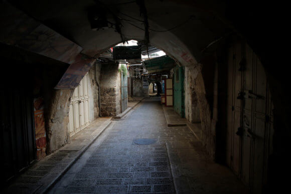 Closed shops in the West Bank city of Nablus, which is under a home confinement order as a precaution against the spread of the coronavirus disease (COVID-19), March 25, 2020. (Photo: Shadi Jarar'ah/APA Images)