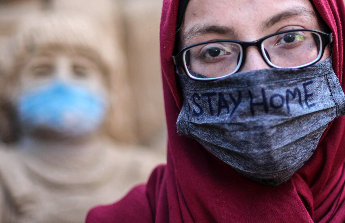 A Palestinian artist Rana el-Ramlawi, 23, creates a sand sculpture "stay home" about the spread of coronavirus, outside her house Gaza City, on April 3, 2020. (Photo: Mahmoud Ajjour)