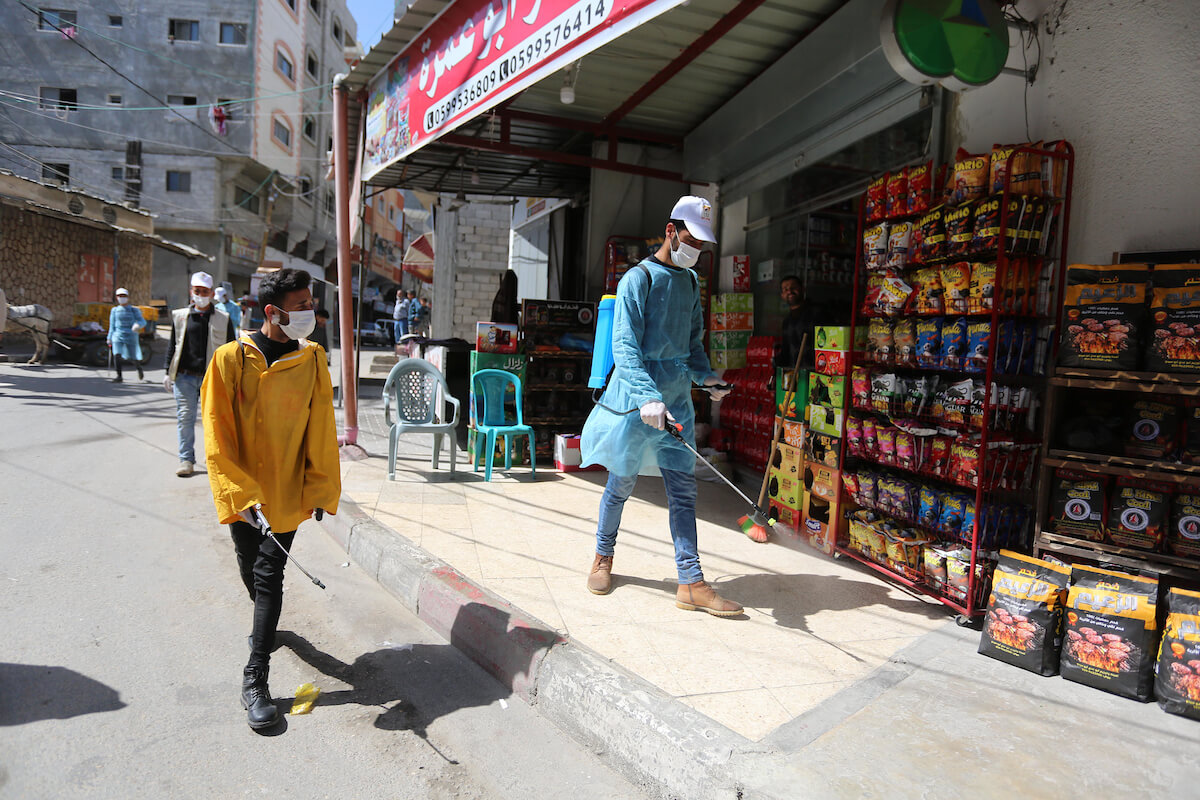 Palestinian workers spray disinfectant as a preventive measure amid fears of the spread of the coronavirus, in Dair Al Balah in the center of Gaza Strip, on April 4, 2020. (Photo: Ashraf Amra/APA Images)