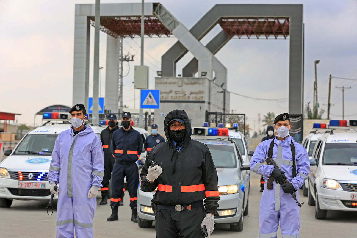 Members of Hamas security forces wear protective gear as a precaution against the coronavirus, at Rafah border crossing with Egypt in the southern Gaza Strip on April 14, 2020. (Photo: Ashraf Amra/APA Images)