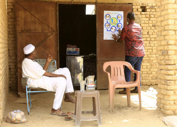 A Sudanese man looks on at posters during awareness campaign about the coronavirus in Jili, Sudan, on March 25, 2020. (Photo: Faiz Abu Bakr/APA Images)