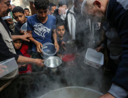 A Palestinian man distributes free food during the holy fasting month of Ramadan. (Photo: Ashraf Amra/APA Images)