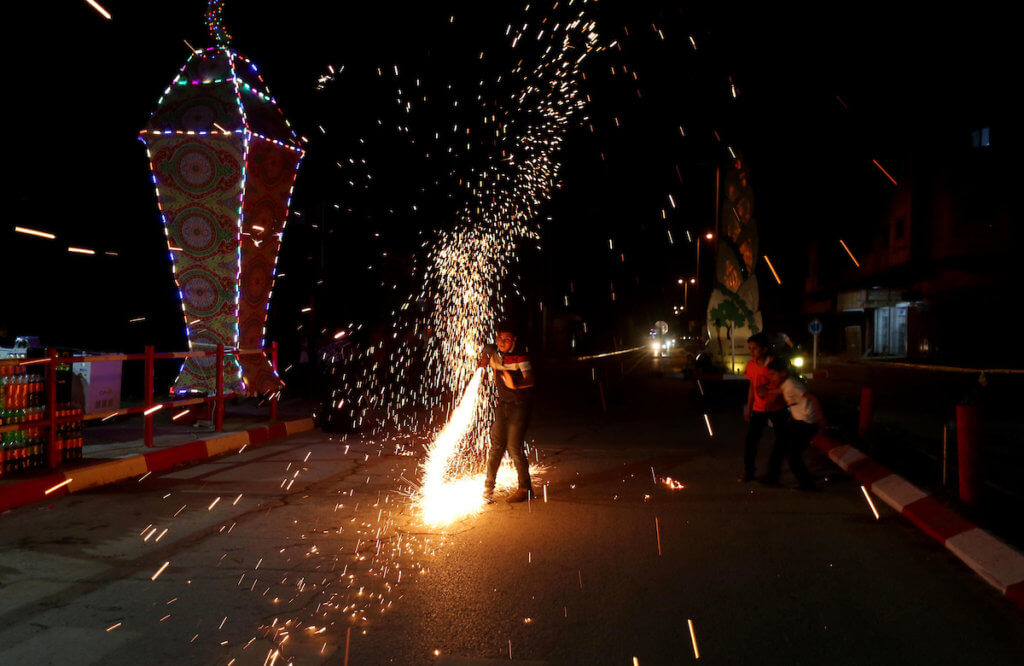 Palestinian children play with fireworks celebrating Ramadan in Khan Yunis in the Gaza Strip on April 22, 2020. (Photo: Ashraf Amra/APA Images)