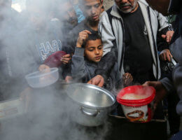 A Palestinian man distributes free food during the holy month of Ramadan in Shuja'iyya neighborhood in Gaza City on April 28, 2020. Muslims around the world celebrate the month of Ramadan by praying during the night time and abstaining from eating and drinking during the period between sunrise and sunset. (Photo: Ashraf Amra/APA Images)