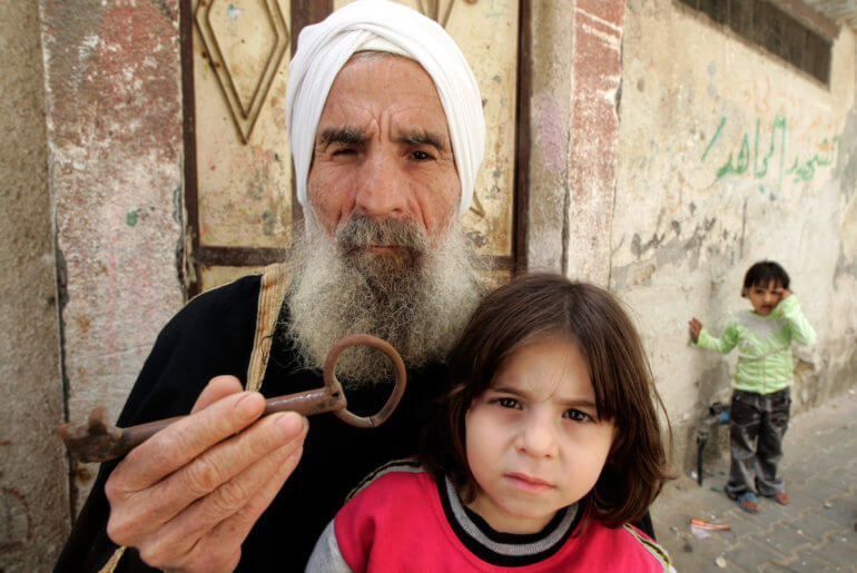 Mohamed Abdel Meguid Gomaa, a Palestinian refugee in the Rafah refugee camp, holds up a key from his family's house which they were forced from during the Nabka in 1948. (Photo: Abed Rahim Khatib/APA Images)