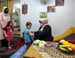 Palestinian Kindergarten teacher wearing a face mask and gloves, play with children after the decision to open schools across the Gaza Strip, in Gaza City, on June 2, 2020. (Photo: Mahmoud Ajjour/APA Images)