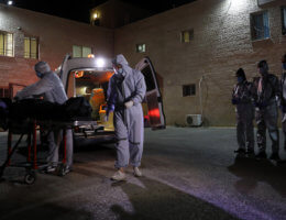 Palestinian health workers move the body of a woman who has died after COVID-19 in the West Bank city of Nablus, July 5, 2020. (Photo: Nablus Governorate Office/APA Images)