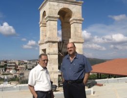 Attorney Sabri Jiryis (L) and Sam Bahour standing on the rooftop of the 113-year-old Saint Elias Church in the Palestinian village of Fassouta in the Western Galilee. The South Lebanon skyline is in the background.