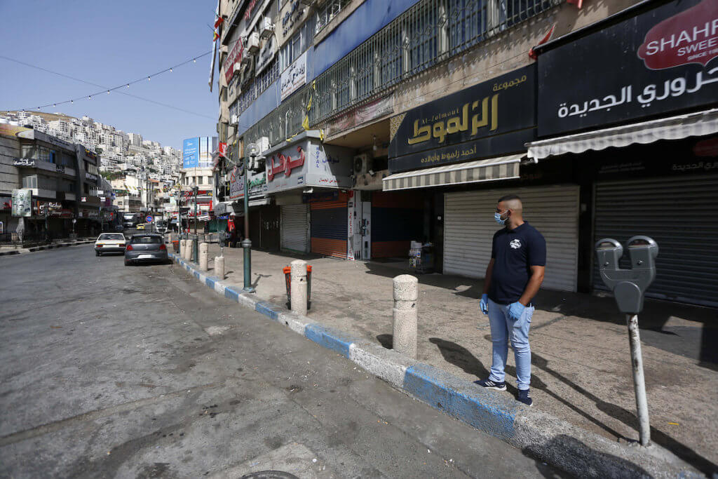 Palestinians walk in the streets during of a mandatory quarantine that was announced by the Palestinian Authority as part of measures against the resurgence of COVID-19 in the West Bank city of Nablus on June 21, 2020. (Photo: Shadi Jarar’ah/APA Images)