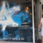 A member of the JDL defacing the Foodbenders storefront (Photo: Twitter)