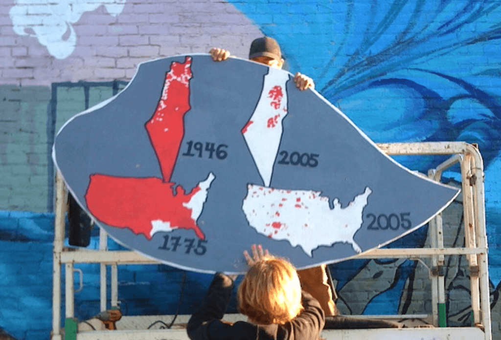The section of the Olympia-Rafah Solidarity Mural in Olympia, WA that draws a comparison between settler colonialism in Palestine and the United States.