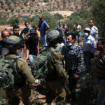 Palestinian demonstrators confront Israeli soldiers during a demonstration against Israel's planned annexation of parts of the occupied West Bank in the town of Beita, south of the West Bank city of Nablus on July 18, 2020. (Photo: Shadi Jarar’ah/APA Images)