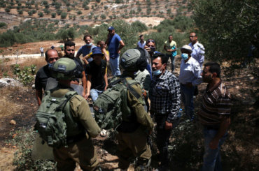 Palestinian demonstrators confront Israeli soldiers during a demonstration against Israel's planned annexation of parts of the occupied West Bank in the town of Beita, south of the West Bank city of Nablus on July 18, 2020. (Photo: Shadi Jarar’ah/APA Images)
