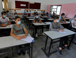 Palestinian students wearing face masks take part in a simulation of returning to schools, as a preventive measure to slow the spread of the coronavirus, organized by the Ministry of Education in Khan Younis in south Gaza on October 4, 2020. (Photo: Ashraf Amra/APA Images)
