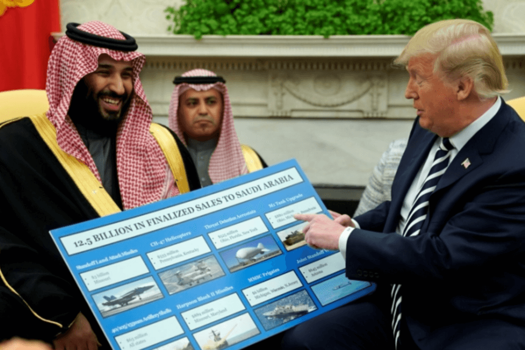 President Donald Trump (R) holds up a chart of military hardware sales as he meets with Crown Prince Mohammed bin Salman of the Kingdom of Saudi Arabia in the Oval Office at the White House on March 20, 2018 in Washington, D.C.