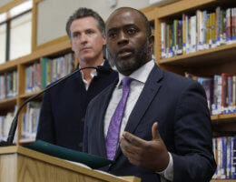 Tony Thurmond, with Gov. Gavin Newsom in the background (Photo: AP)