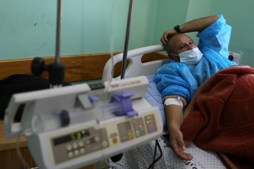 A coronavirus patient in an isolation unit at al-Aqsa hospital, in Deir Al-Balah, in the central Gaza Strip, on December 6, 2020. (Photo: Ashraf Amra/APA Images)