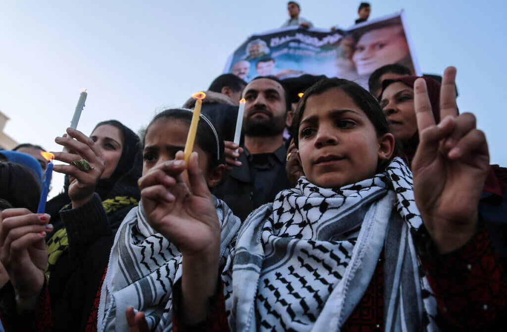Palestinian children hold candles during a protest in support of teenager Ahed Tamimi, then 16, on January 8, 2018. Israel charged Tamimi with 12 counts including assault on January 1 following her arrest after a video of her slapping and kicking two Israeli soldiers in the West Bank went viral. (Photo: Mohammed Dahman/APA Images)