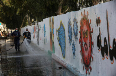 Palestinian workers spray disinfectant as a preventive measure amid fears of the spread of the coronavirus in the center of Gaza strip, on December 12, 2020. (Photo: Ashraf Amra/APA Images)