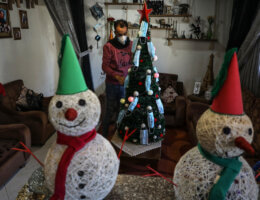 Palestinian artist Wissam Farhat decorates a Christmas tree with face masks amid the pandemic in Gaza City on December 20, 2020. (Photo: Mahmoud Ajjour/APA Images)