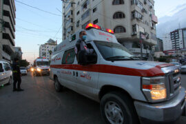 Palestinian EMTs take part in an awareness campaign for drivers about the coronavirus disease, in Gaza City on November 28, 2020. (Photo: Mahmoud Ajjour/APA Images)