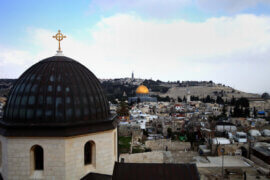 A general view from the tower of the Church of Redeemer shows the Dome of the Rock and the cross of the Church of the Holy Sepulchre in the old city of Jerusalem, on February 17, 2014. Photo by Saeed Qaq
