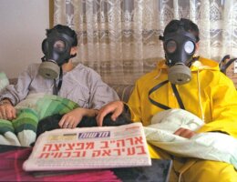 An Israeli family wearing gas masks during the Gulf War in 1991. (Photo: Nathan Alpert, Israeli Government Press Office)