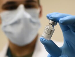 File Photo: Medical professional holds a vial of the Pfizer-BioNTech COVID-19 vaccine in December 2020. (Photo: Lisa Ferdinando/Wikimedia)