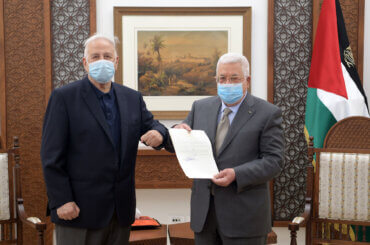 Palestinian President Mahmoud Abbas, hands over the election decree to the head of the Central Election Commission Nasser Hanna, in the West Bank city of Ramallah, on January 15, 2021. (Photo: Thaer Ganaim/APA Images)
