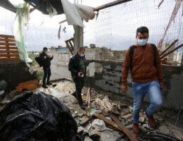 Palestinian men inspect a damaged house near the border fence with Israel in Maghazi refugee camp in the central Gaza on January 20, 2021. (Photo: Ashraf Amra/APA Images)